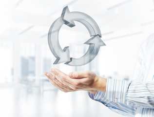 Web refresh icon in male hands as symbol for internet use. Mixed media