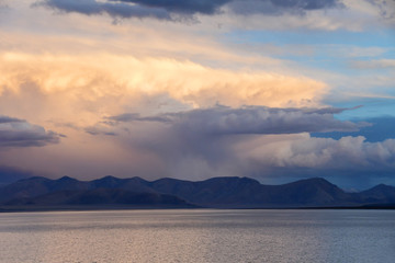 China. Great lakes of Tibet. Large clouds over lake Teri Tashi Namtso at sunset