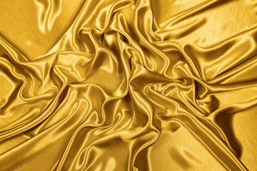 Gold luxury satin fabric texture for background and art design
