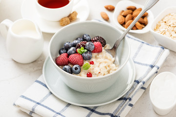 Healthy breakfast. Oatmeal with berries and nuts .