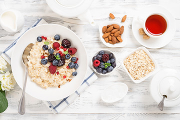 Healthy breakfast. Oatmeal with berries and nuts .