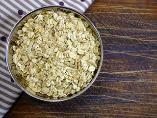 Pile of oatmeal in a heart shaped dish. Concept of healthy eating, vegan food, healthy food. Top view