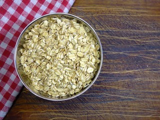 Pile of oatmeal in a heart shaped dish. Concept of healthy eating, vegan food, healthy food. Top view