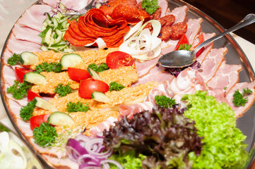 plate with meat, tomatoes, salat, onion
