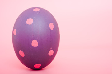 Beautiful Easter purple egg color on pink background