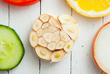 Sliced fruits, vegetables on white wooden table