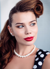 Retro (vintage) portrait of beautiful smiling young woman. Close-up