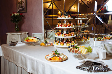 Variety assortment of different luxury food snacks and appetizers, concept of decorated catering banquet set, on a party event celebration