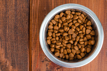 Metal bowls with various pet food.