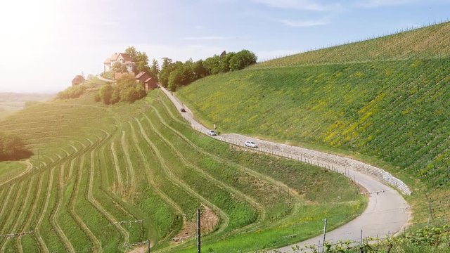 DURBACH, GERMANY - CIRCA 2019: Burg Schloss Staufenberg castle in Baden Wurttemberg village - elevated still drone view with cars on the serpentine road over the winery roads
