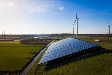 Solar panels and wind turbines generating eco friendly green energy for a better environment near Waalwijk, Noord-Brabant, Netherlands.