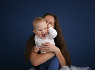 mom holds the baby in her arms, blue background