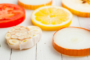 Sliced fruits, vegetables on white wooden table