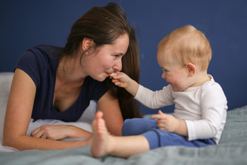 baby feeds mother with bread,motherhood and care