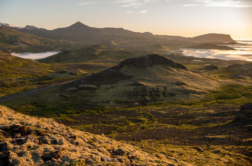  Dreamy misty landscape above the sea of clouds, mountains at sunset in Iceland