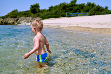 Toddler boy on beach
