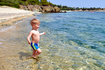 Toddler boy on beach