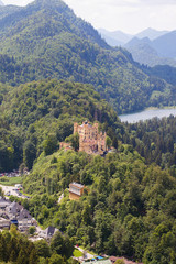 Fototapeta na wymiar View from the air to the Schloss Hohenschwangau castle in the Alpine mountains