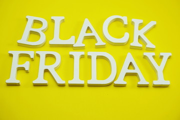 Black Friday sale shopping concept alphabet on yellow background