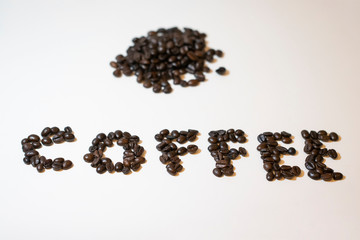 Pile of roasted coffee beans. On white background