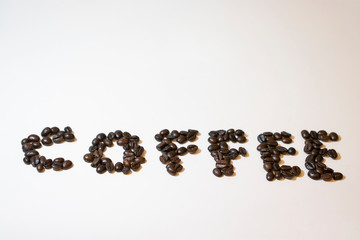 Pile of roasted coffee beans. On white background