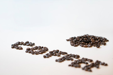 Pile of roasted coffee beans. On white background