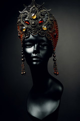 Mannequin in creative goldish red Russian kokoshnik with jewels
