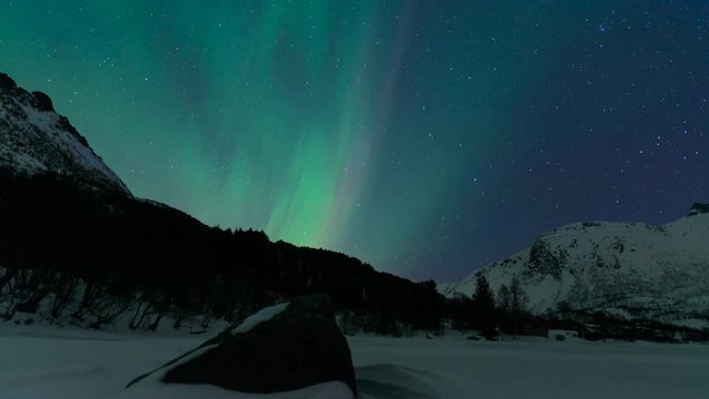 Northern Lights, polar light or Aurora Borealis in the night sky over the Lofoten islands in Northern Norway time lapse.
