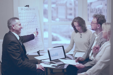 confident businessman showing business partners a new commercial