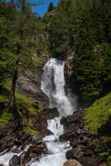beautiful waterfall in a wood on the Italian Dolomites