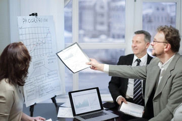 business team and investors discussing the company's profit