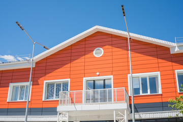 The facade of a residential building in orange color.