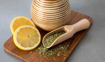 Traditional Yerba Mate tea with matero and bombilla, healthy, energy boosting beverage drink on neutral stone gray background.