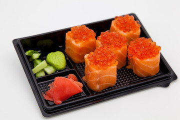 Japanese traditional cuisine, ready-made rolls and sushi in the package, on a white background, for the application and design of fast-food