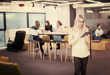 blonde businesswoman working online using digital tablet