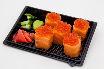 Japanese traditional cuisine, ready-made rolls and sushi in the package, on a white background, for the application and design of fast-food