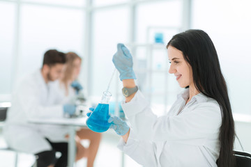 close up.female laboratory assistant takes a sample of the liquid