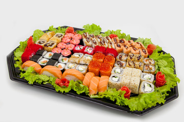 Japanese traditional cuisine, ready-made rolls and sushi in the package, on a white background, for the application and design of fast-food
