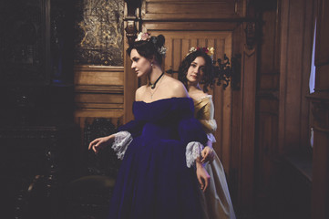 Ladies in 19th century ball dresses