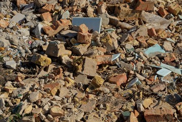 stone texture from garbage pieces of brown bricks and tiles in a pile on the ground