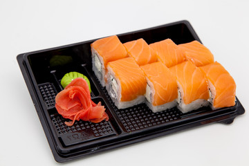 Japanese traditional cuisine, ready-made rolls and sushi in the package, on a white background, for the application and design of fast-food