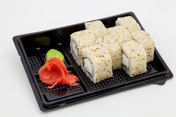 Japanese traditional cuisine, ready-made rolls and sushi in the package, on a white background, for the application and design of fast-food