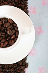 modern white espresso  cup filled with coffee beans and copy space