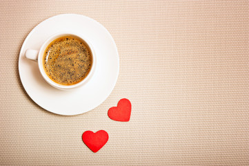 white cup with espresso or moka coffee with red hearts like a concept for I love coffee