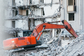 Cleaning of construction debris with a bucket of an excavator/ building demolition excavator, heavy...