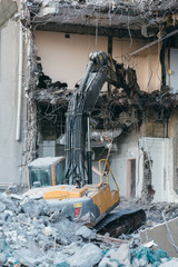 Vertical photo of building demolition excavator/destruction of a building, house ruins,...
