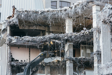 Cropped photo of building demolition excavator/ demolition of a building, house ruins,...