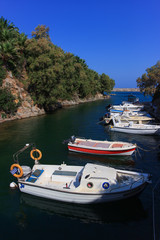 Fototapeta na wymiar beautiful views of Crete. Crete poster. fishing boats in the Bay 