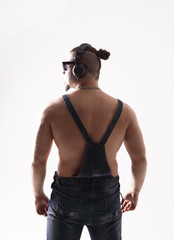 rapper in jeans overalls dancing breakdance .isolated on white background