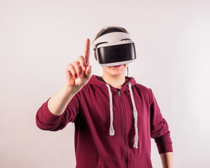 Teenage student man virtual reality headset or 3d glasses, playing video game, gesturing with his hands and catching something.